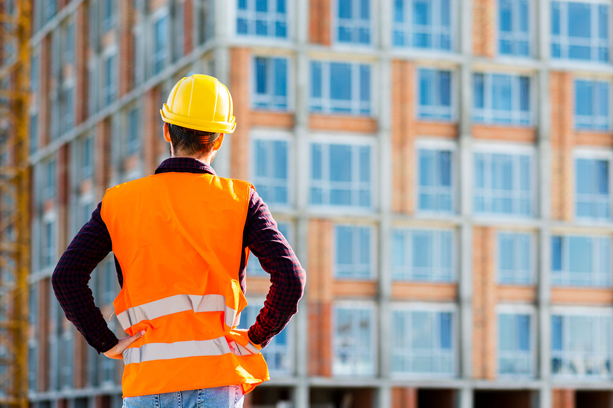 Construction worker looking across an active site