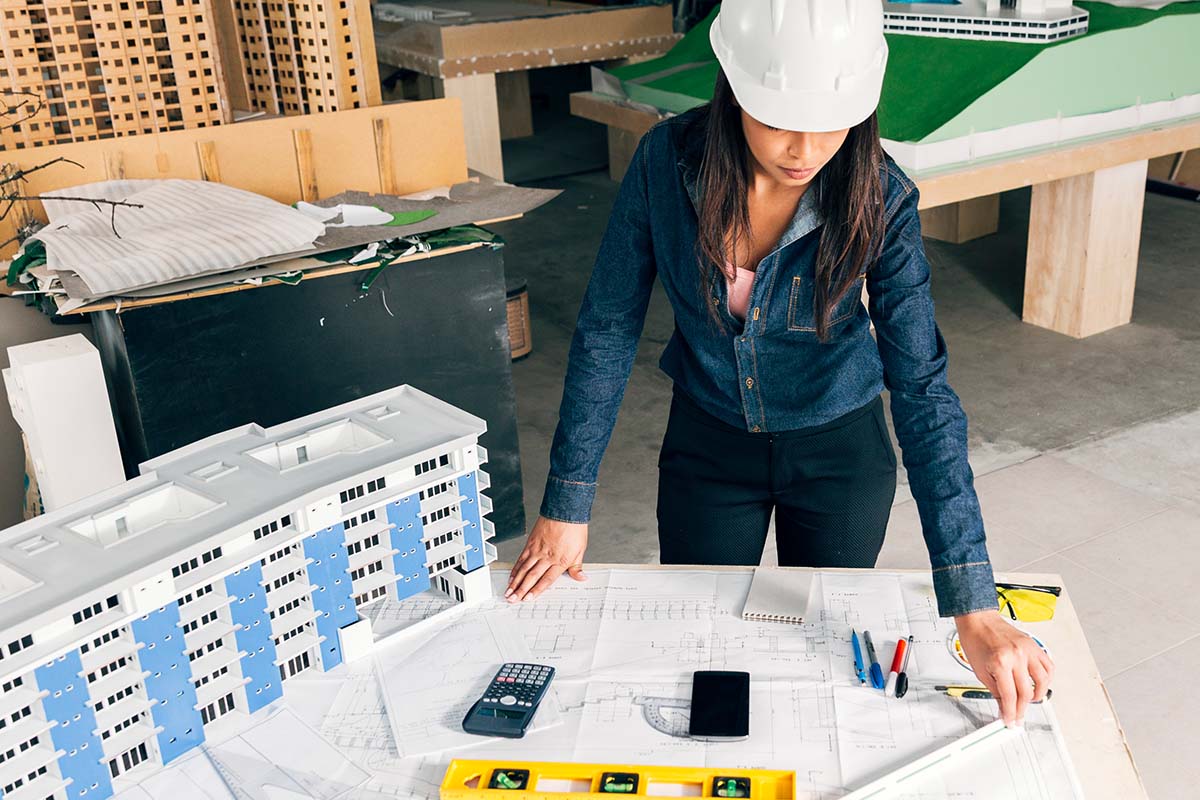 Engineer reviewing technical blueprints